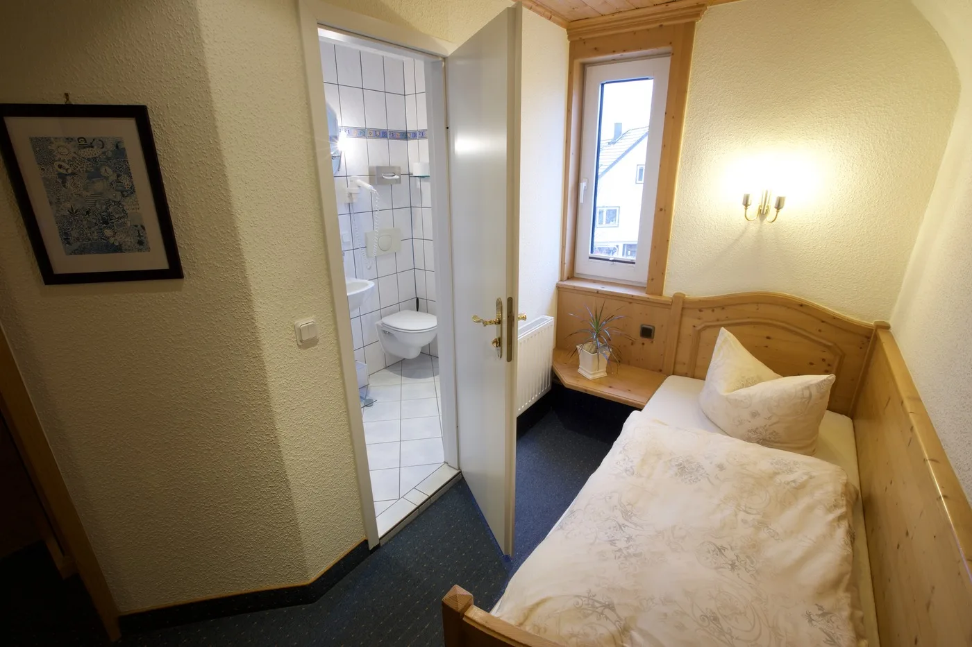Dreibettzimmer mit Einzelbett, Bild an der Wand und eigenem Bad